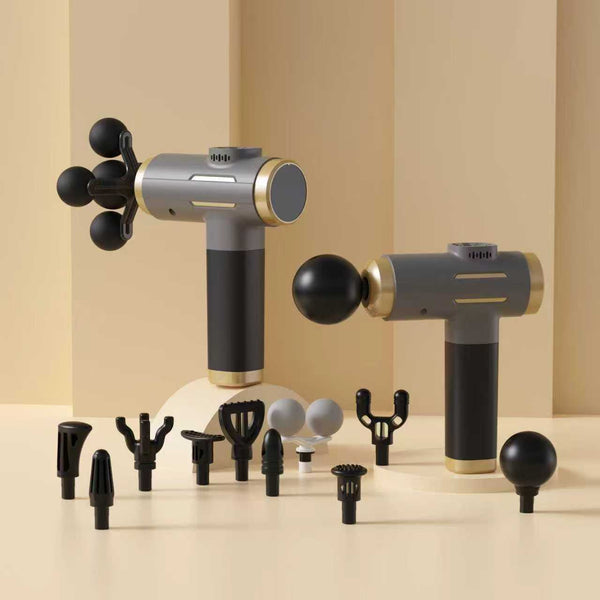 Massage gun with multiple attachments on a beige background