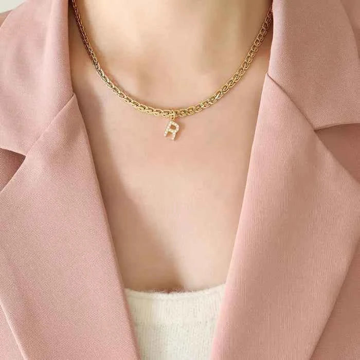 Letter pendant necklace in brass with zircon inlay — primary view