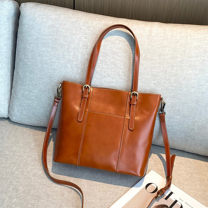 Leather tote bag shown carried on shoulder