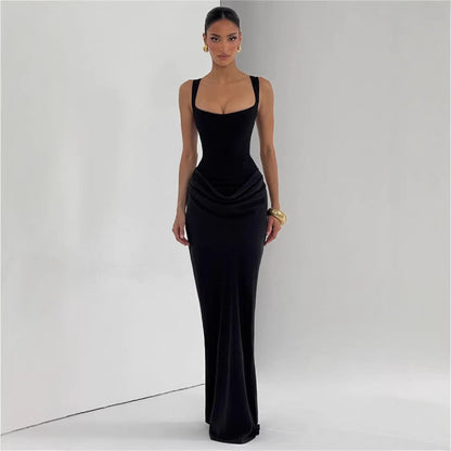 Woman wearing a black evening gown against a plain background